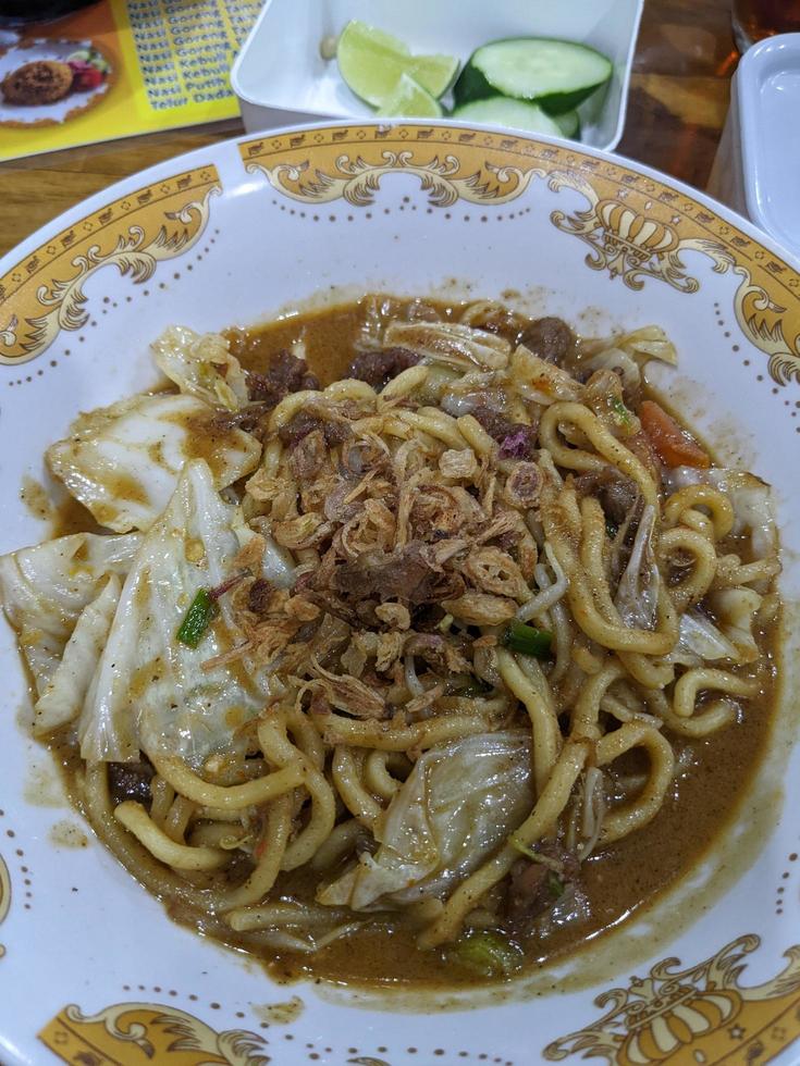 Close up photo of traditional noodles with vegetables topping.