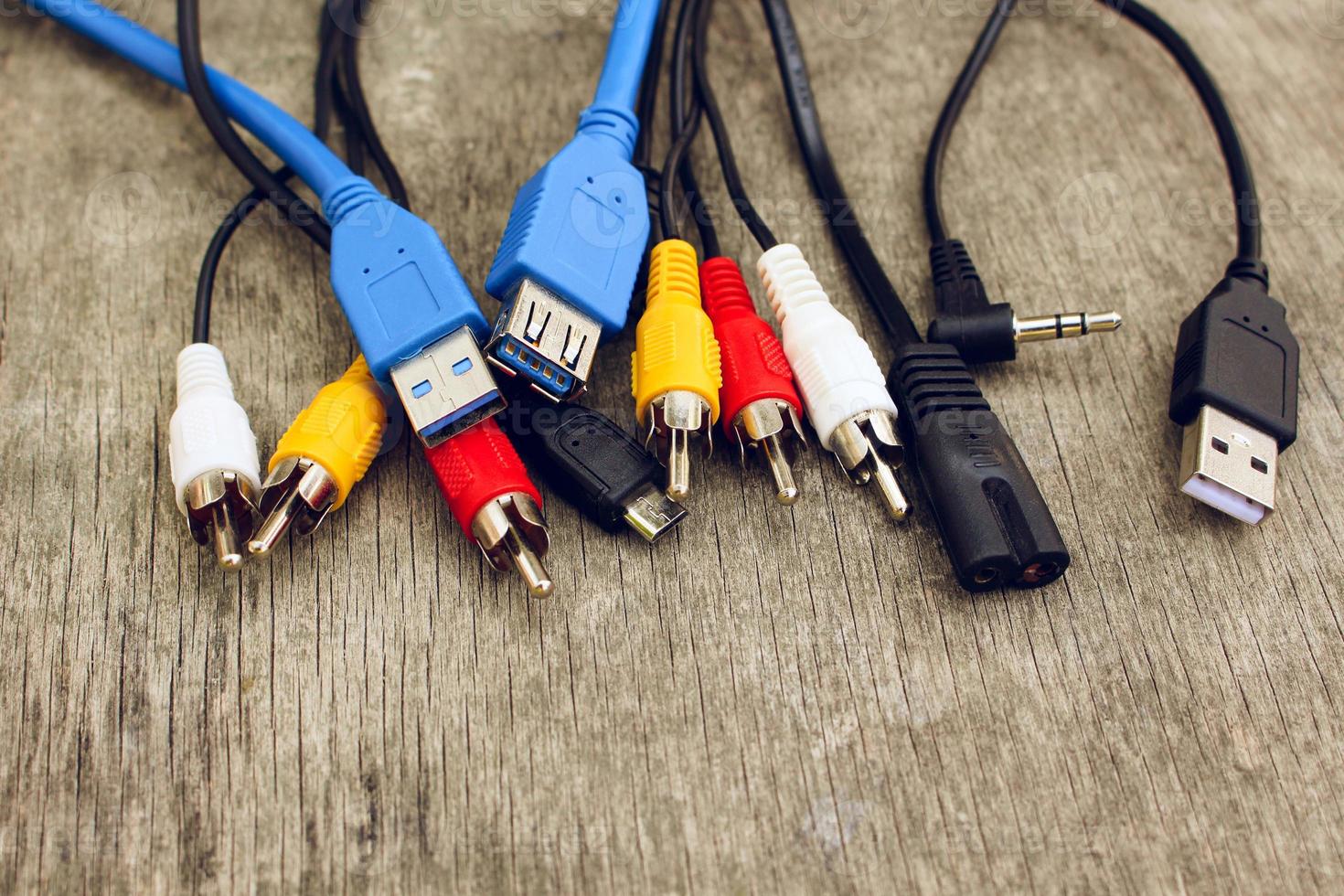 Connection plugs and wires on old wooden background. photo