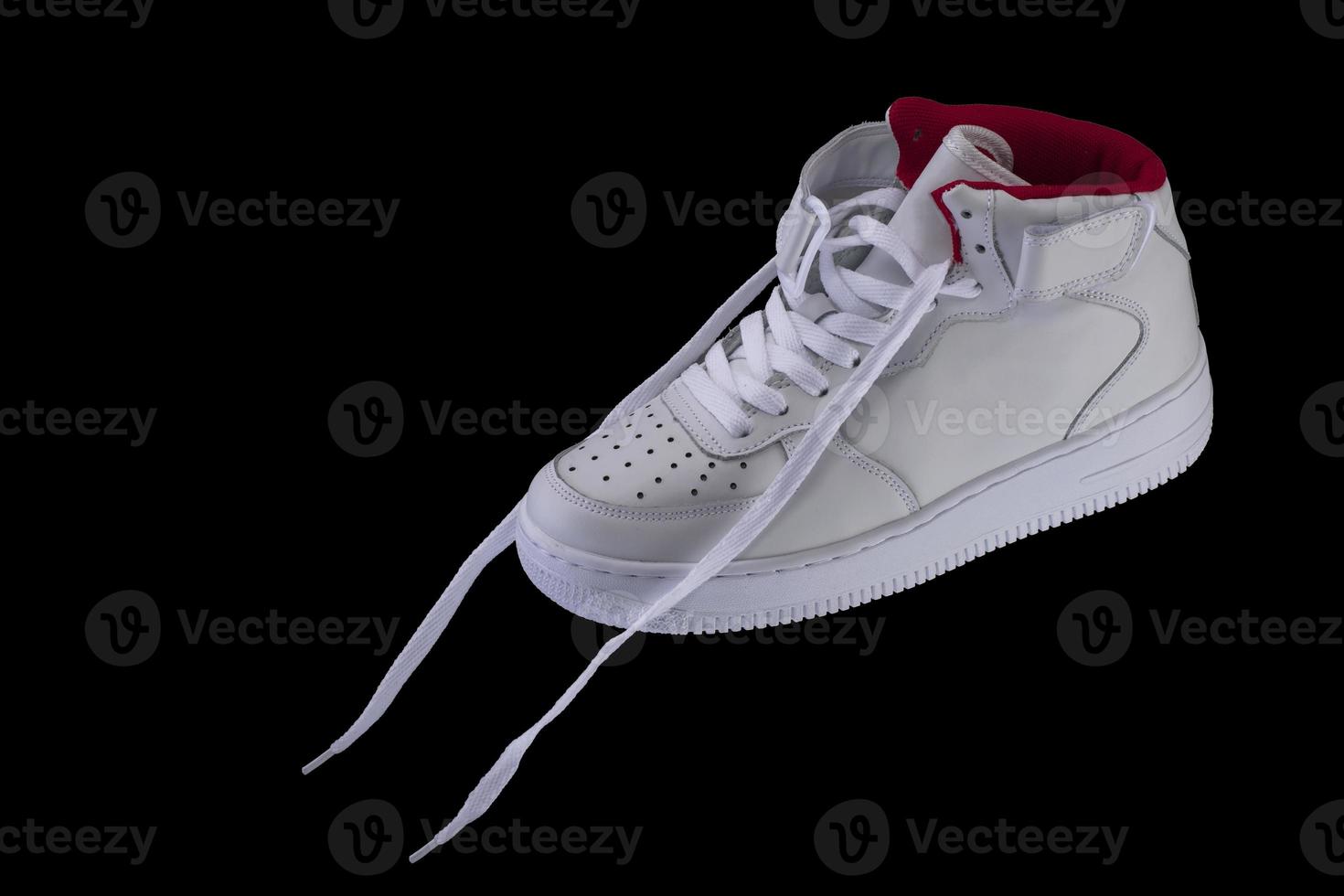 White sneakers with laces on a black background photo
