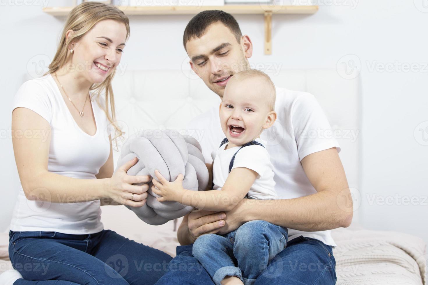 mamá, papá y pequeño hijo son jugando a hogar. joven familia con un niño. foto