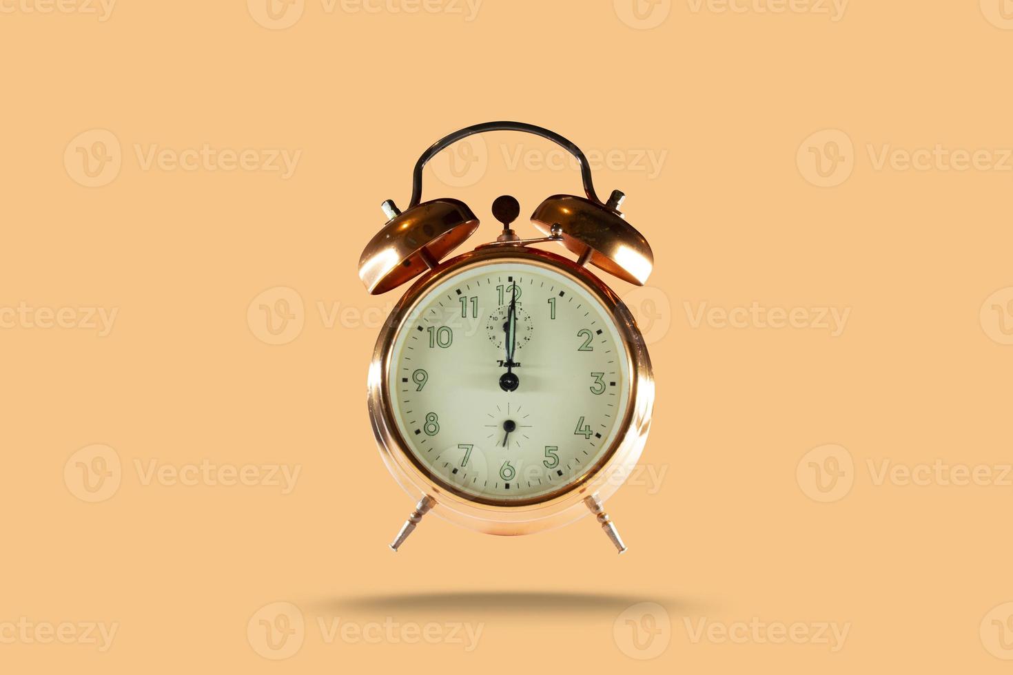 old alarm clock on a beige pastel background, minimal concept photo