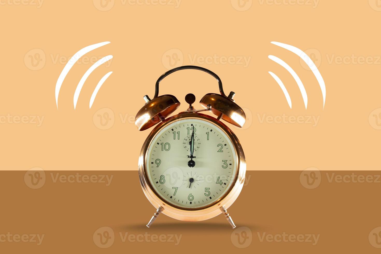 An old alarm clock isolated on a pastel background. Illustrated bell photo