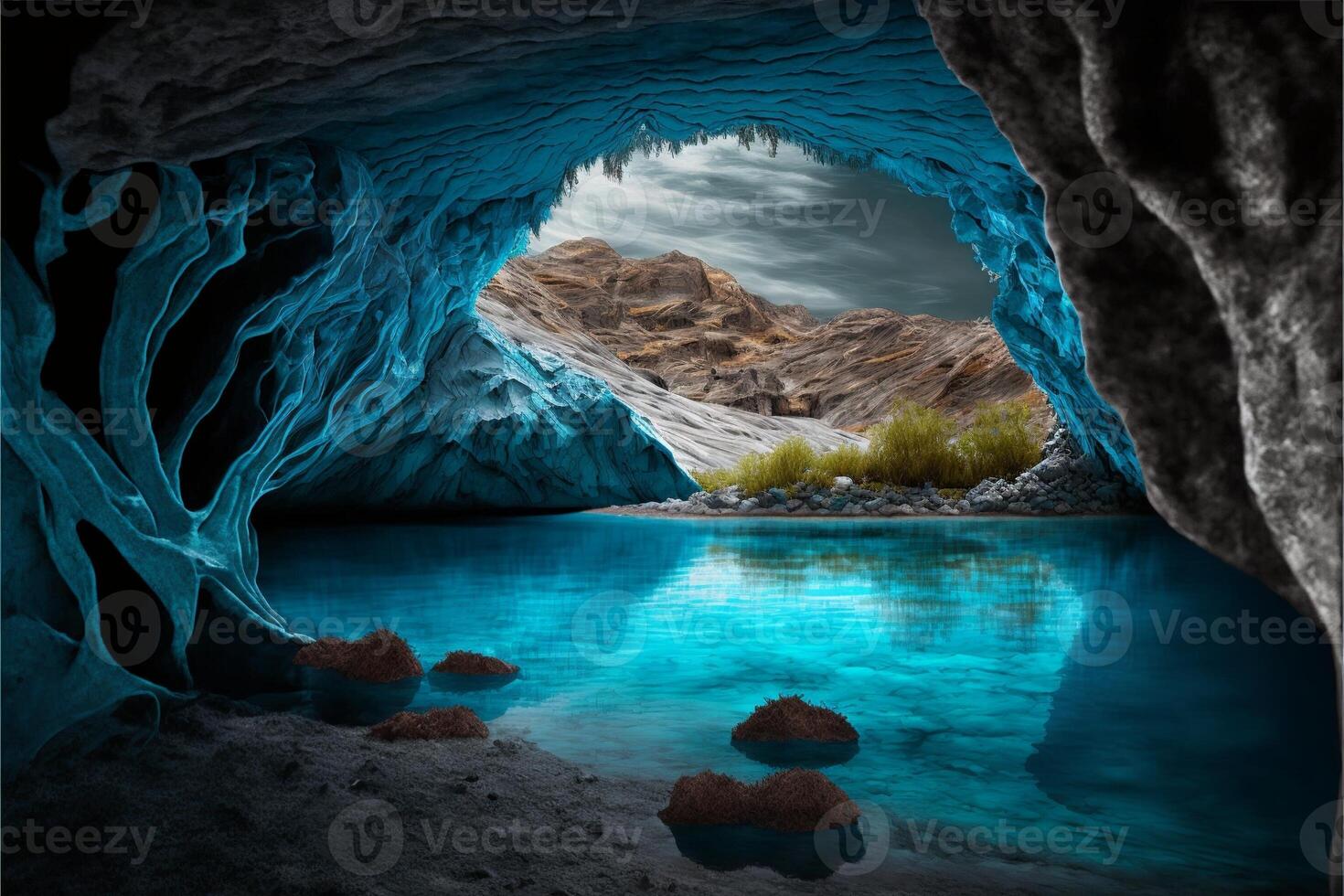 Cave with lake of blue water with mountains in the background. photo