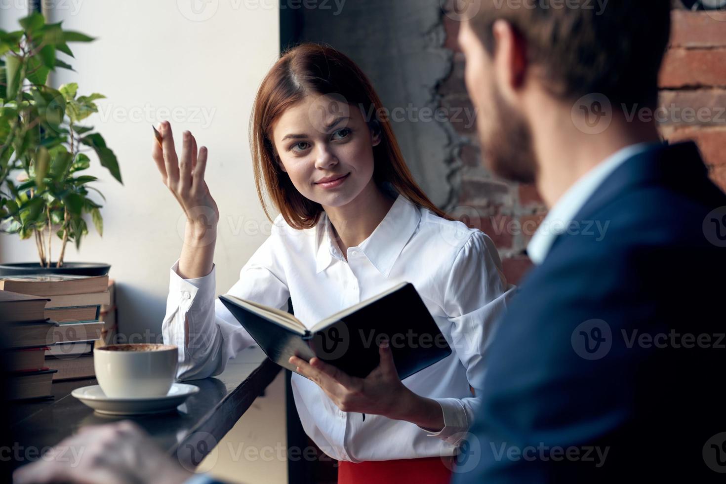 cheerful colleagues sitting in a cafe breakfast communication professionals photo