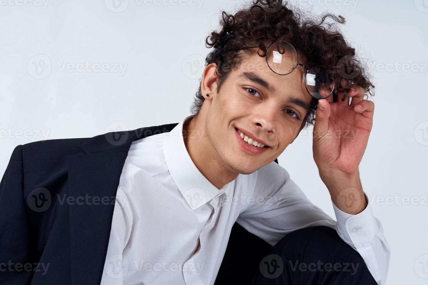 pretty guy in glasses and in a classic suit on a light background portrait close-up fashion style photo
