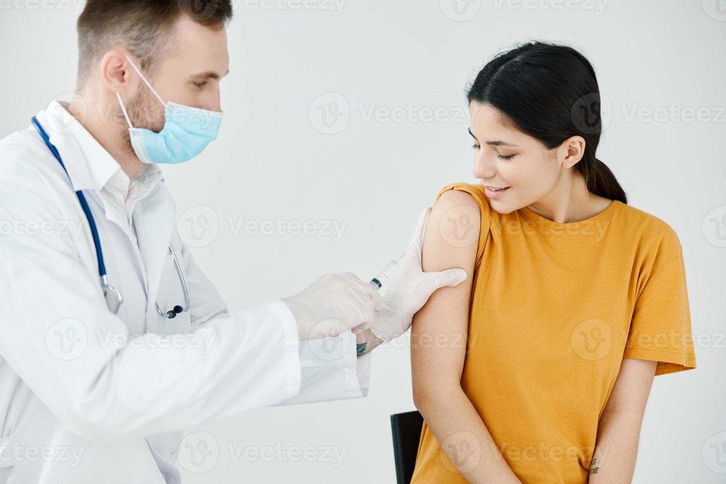 el médico cintas el inyección en el del paciente hombro codicioso vacunación foto