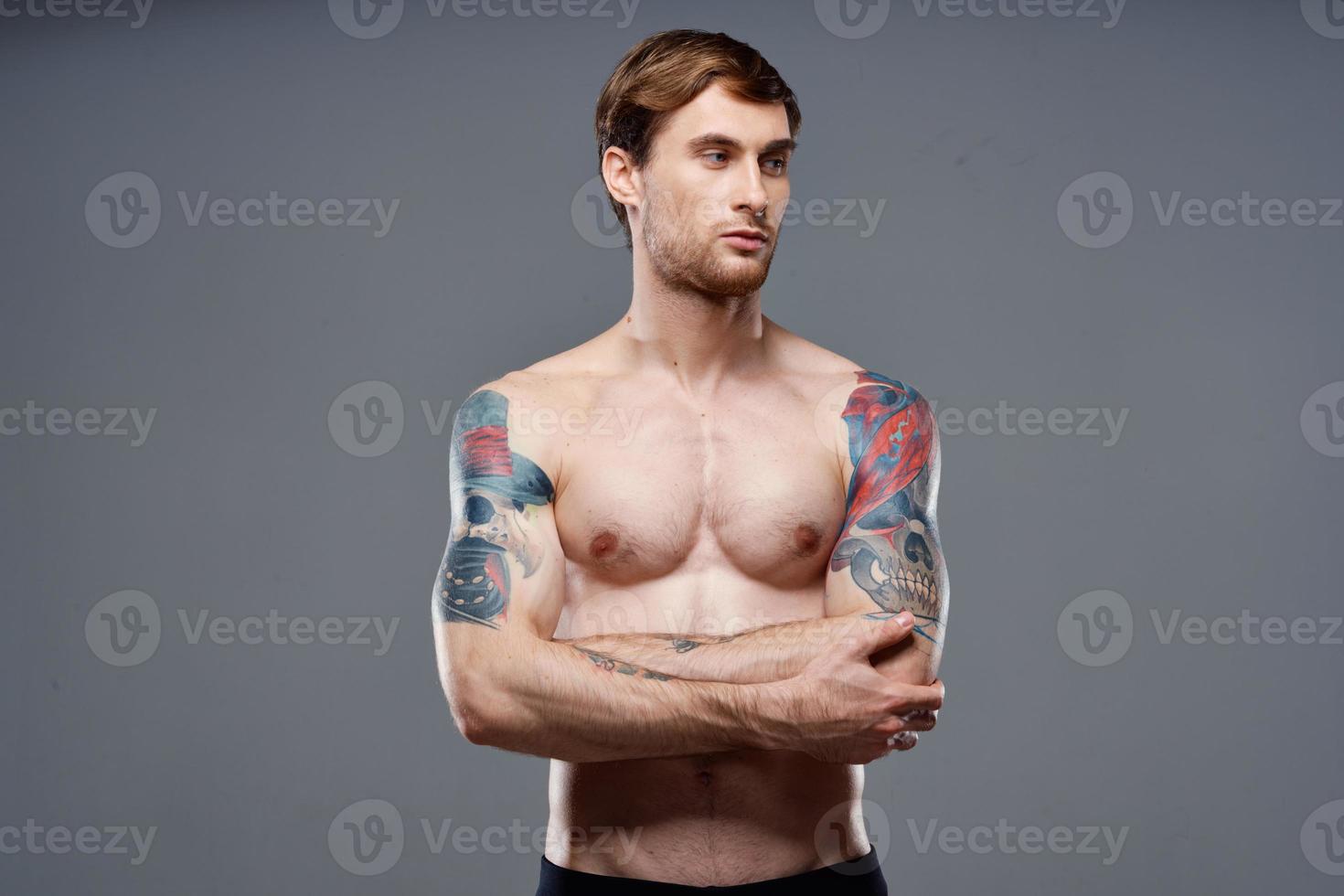 man with tattoos on his arms pumped up torso workout cropped view bodybuilder photo