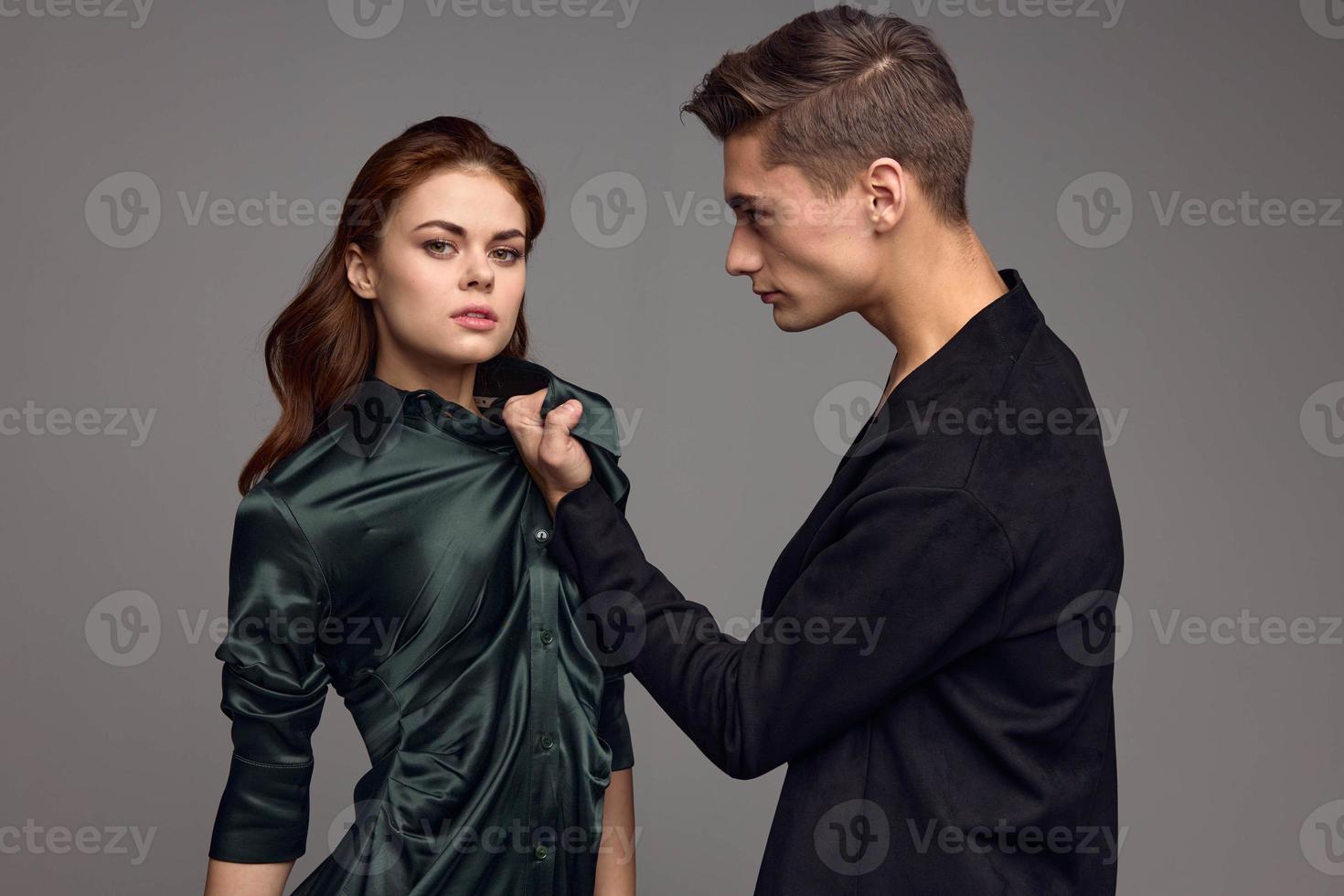 Beautiful woman in dark dress and aggressive man irritability conflict photo