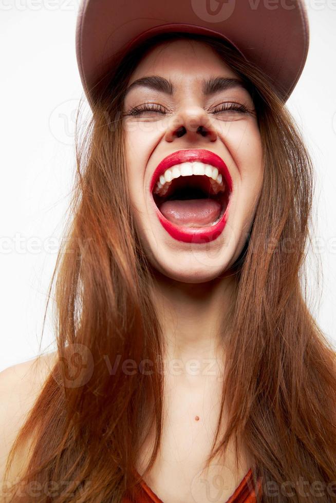 Woman with a cap Joy emotions open mouth closed eyes on her head red dress photo