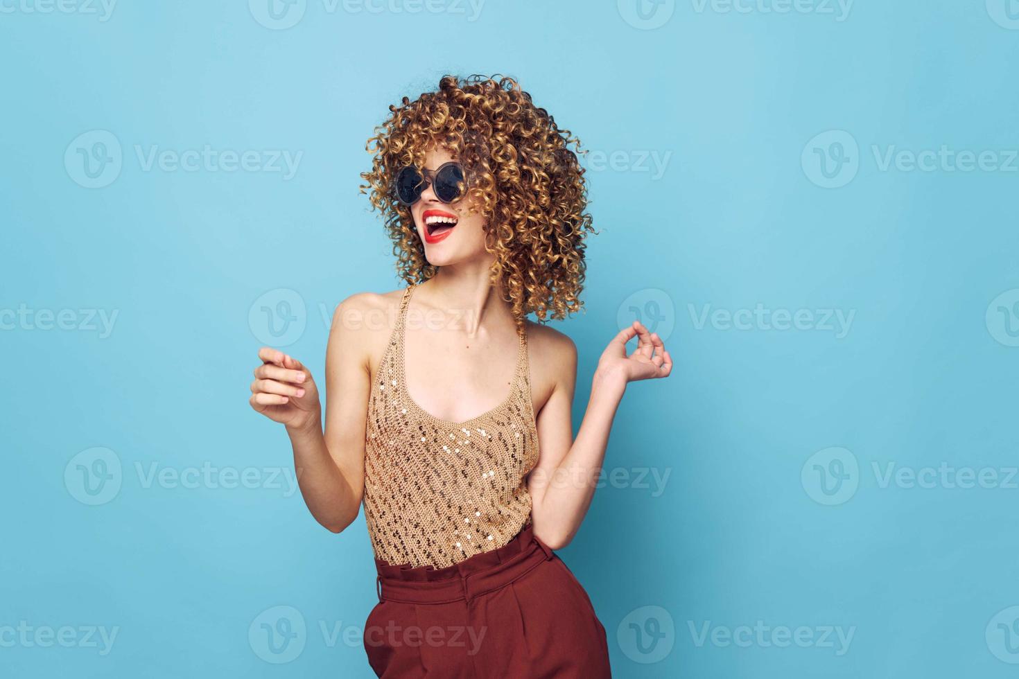 Charming model Curly hair sunglasses smile red lips studio red pants photo