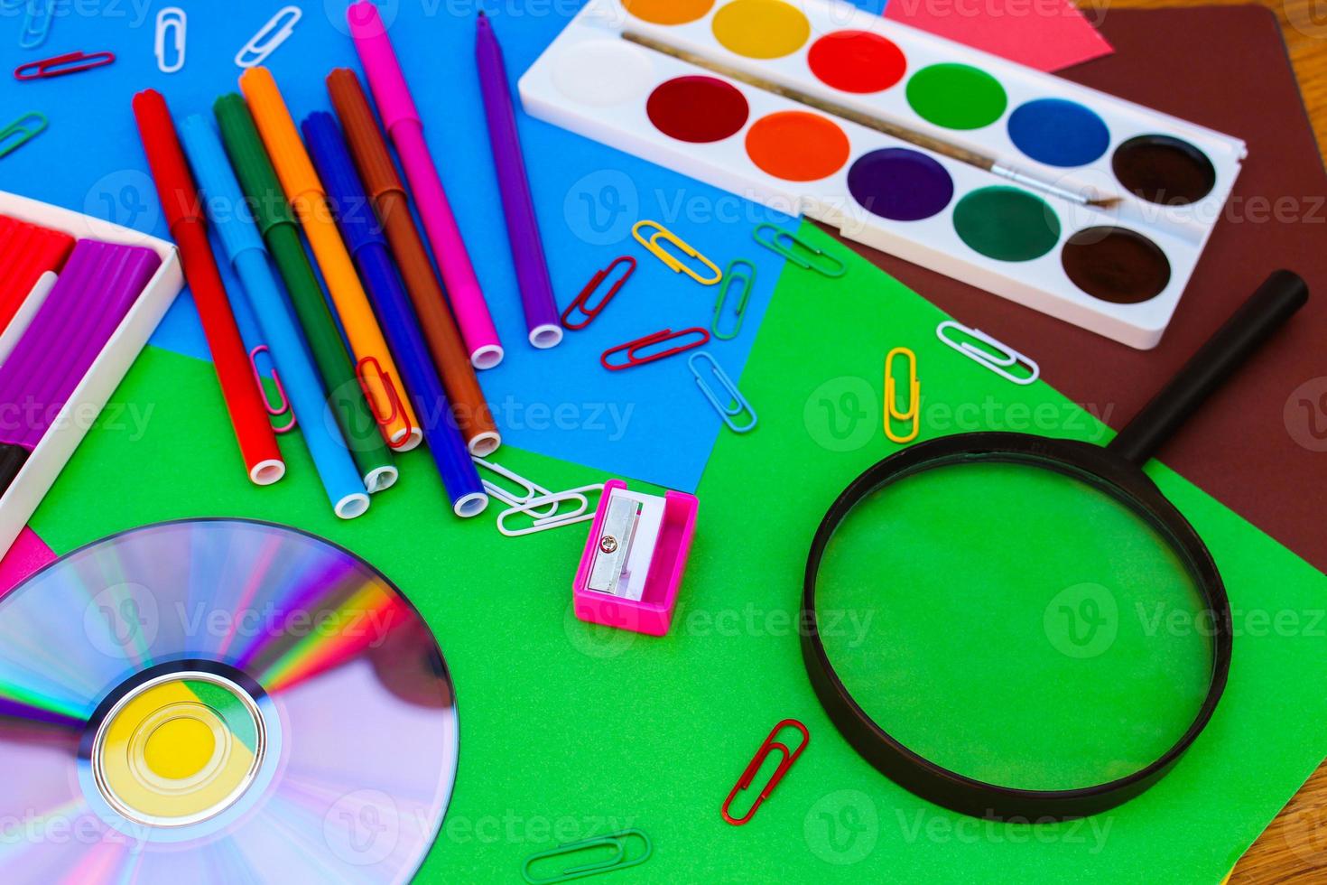 Stationery objects. School and office supplies on the background of colored paper. photo