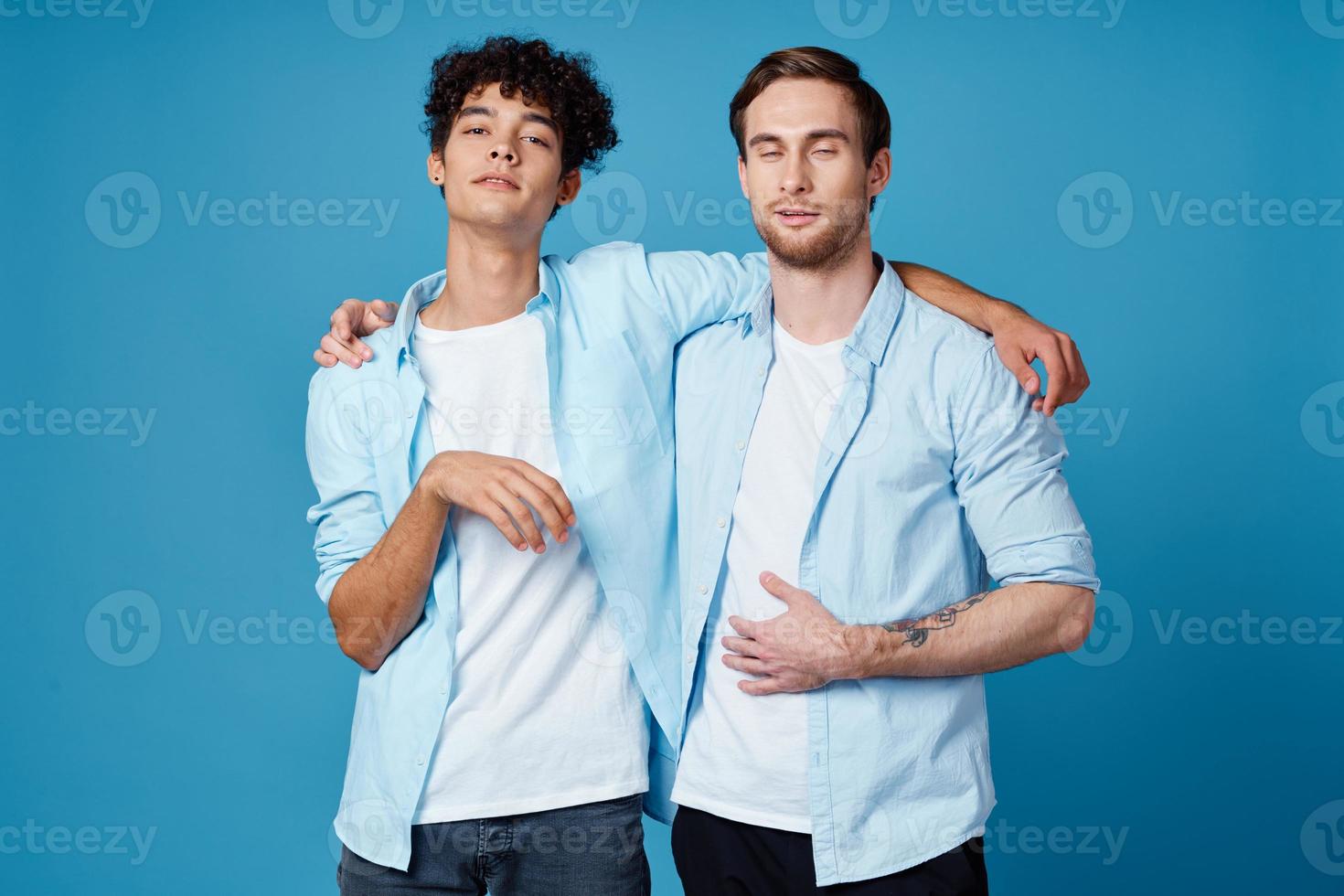 friends hugging on a blue background fun matching shirts white t-shirt pants photo