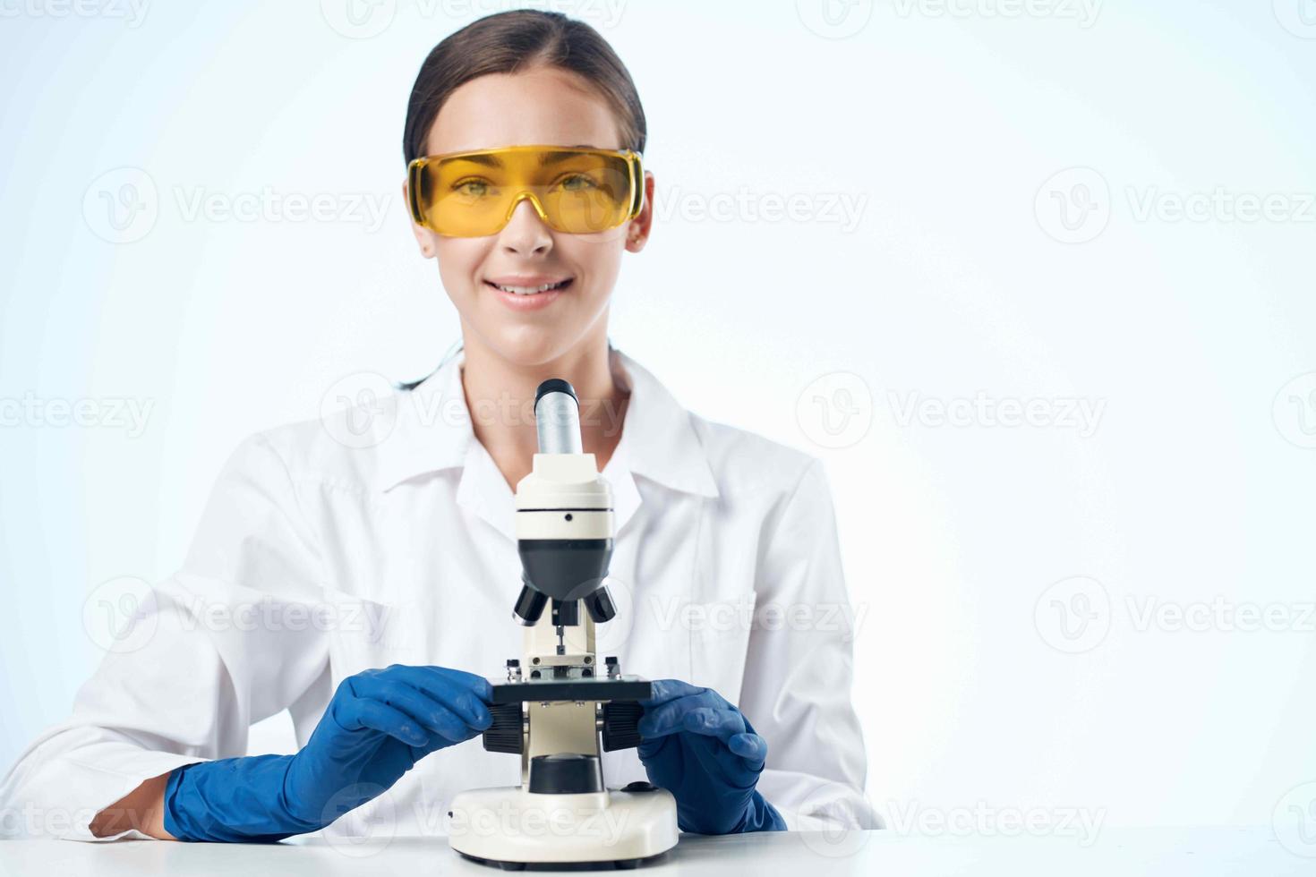 Woman in white coat laboratory microscope research biotechnology photo