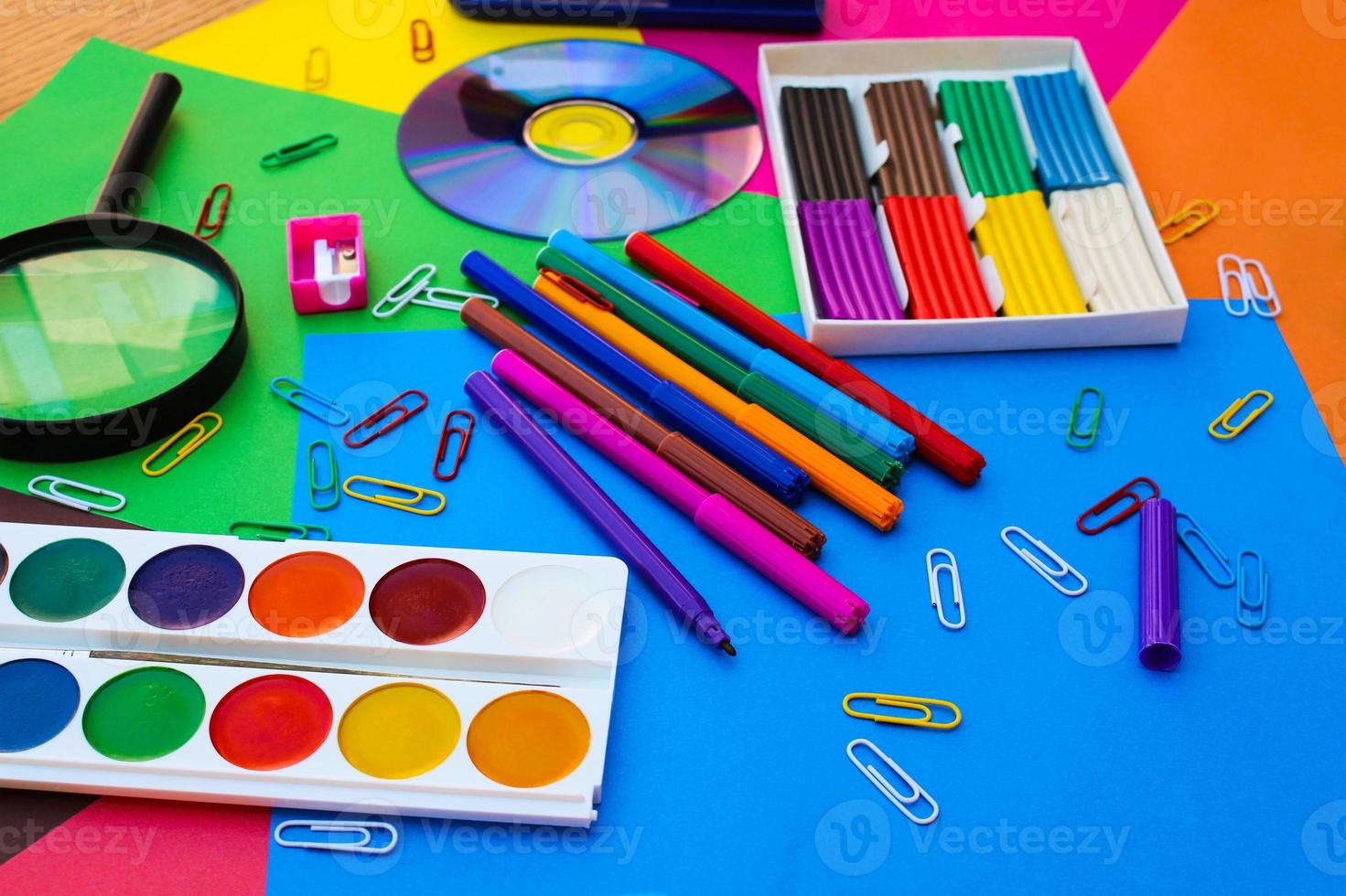 Stationery objects. School and office supplies on the background of colored paper. photo