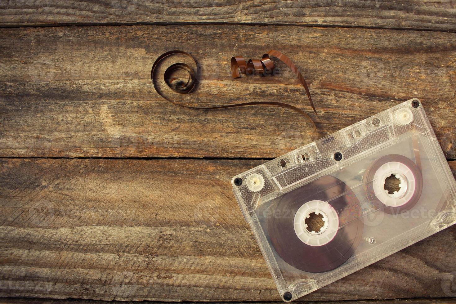 Audio cassette on the old wooden background. Toned image. photo