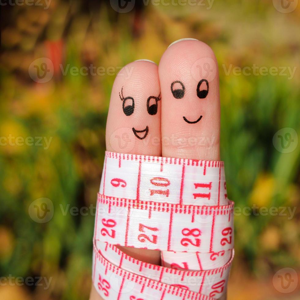 Finger art of a Happy couple with meter. The concept of losing weight together. photo