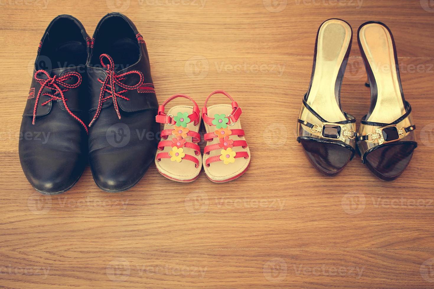 Three pairs of shoes men, women and children photo