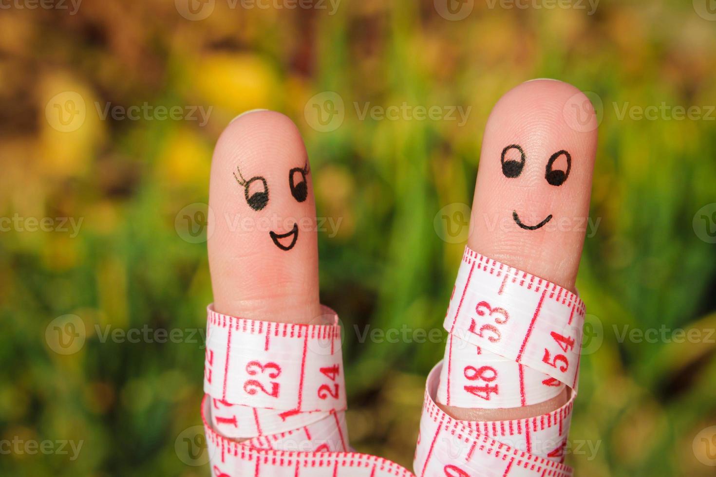 Finger art of a Happy couple with meter. The concept of losing weight together. photo