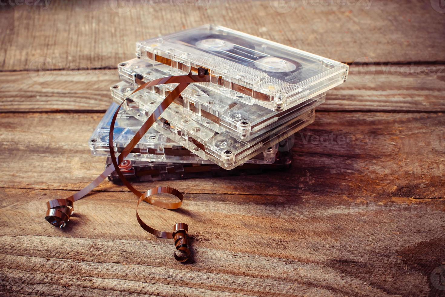 Audio cassette on the old wooden background. Toned image. photo