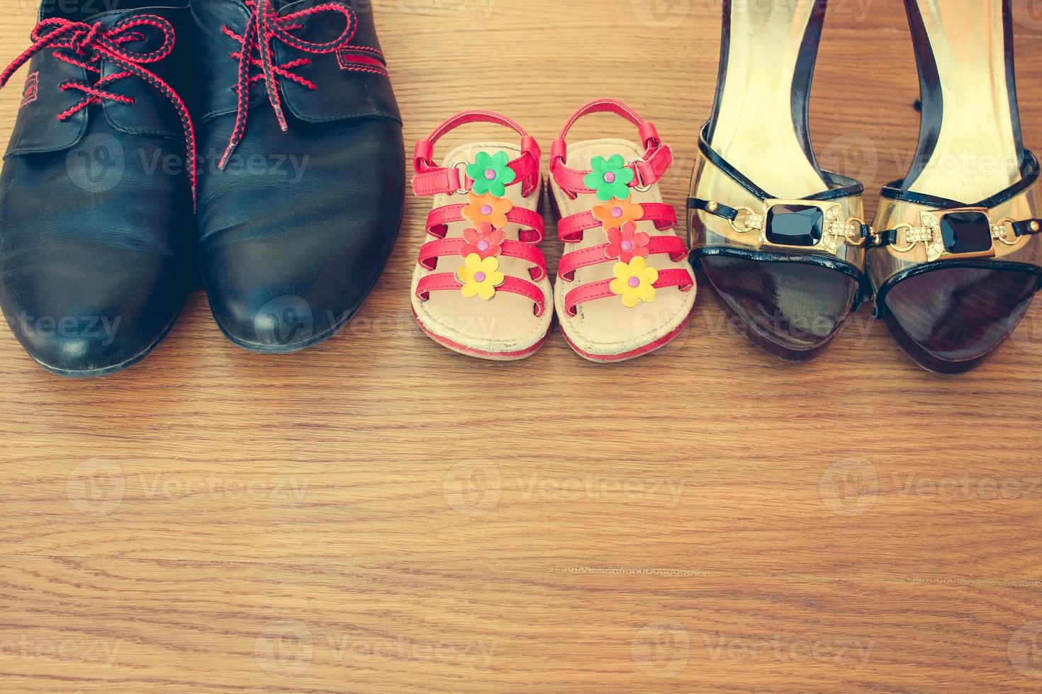 Three pairs of shoes men, women and children. photo