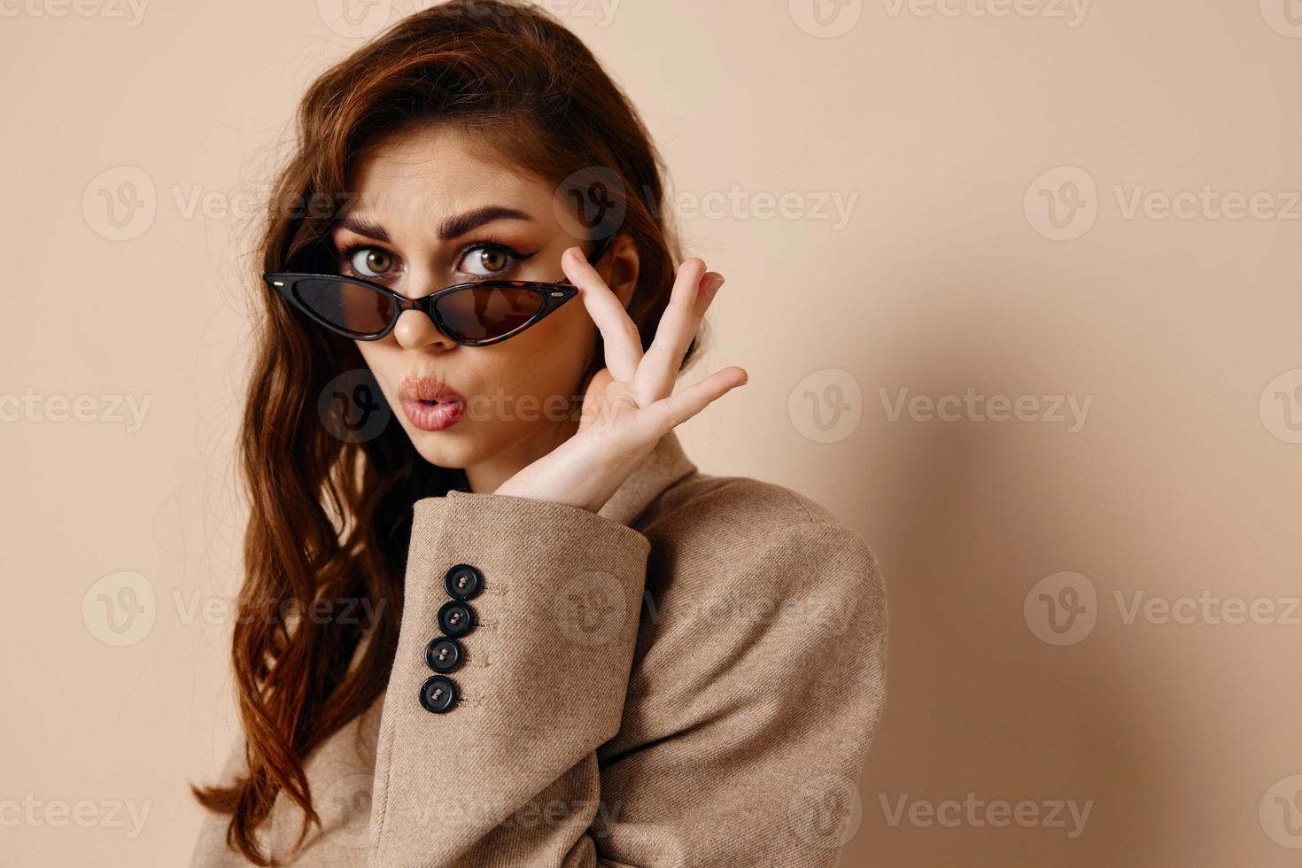 glamorous woman in beige coat and sunglasses makeup photo