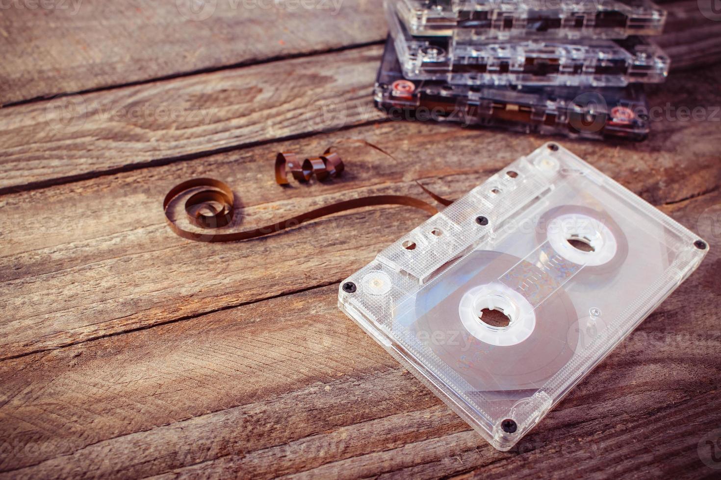 Audio cassette on the old wooden background. Toned image. photo