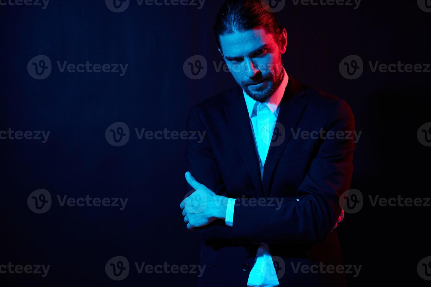 portrait of a man gestures with his hands attractive look neon light photo