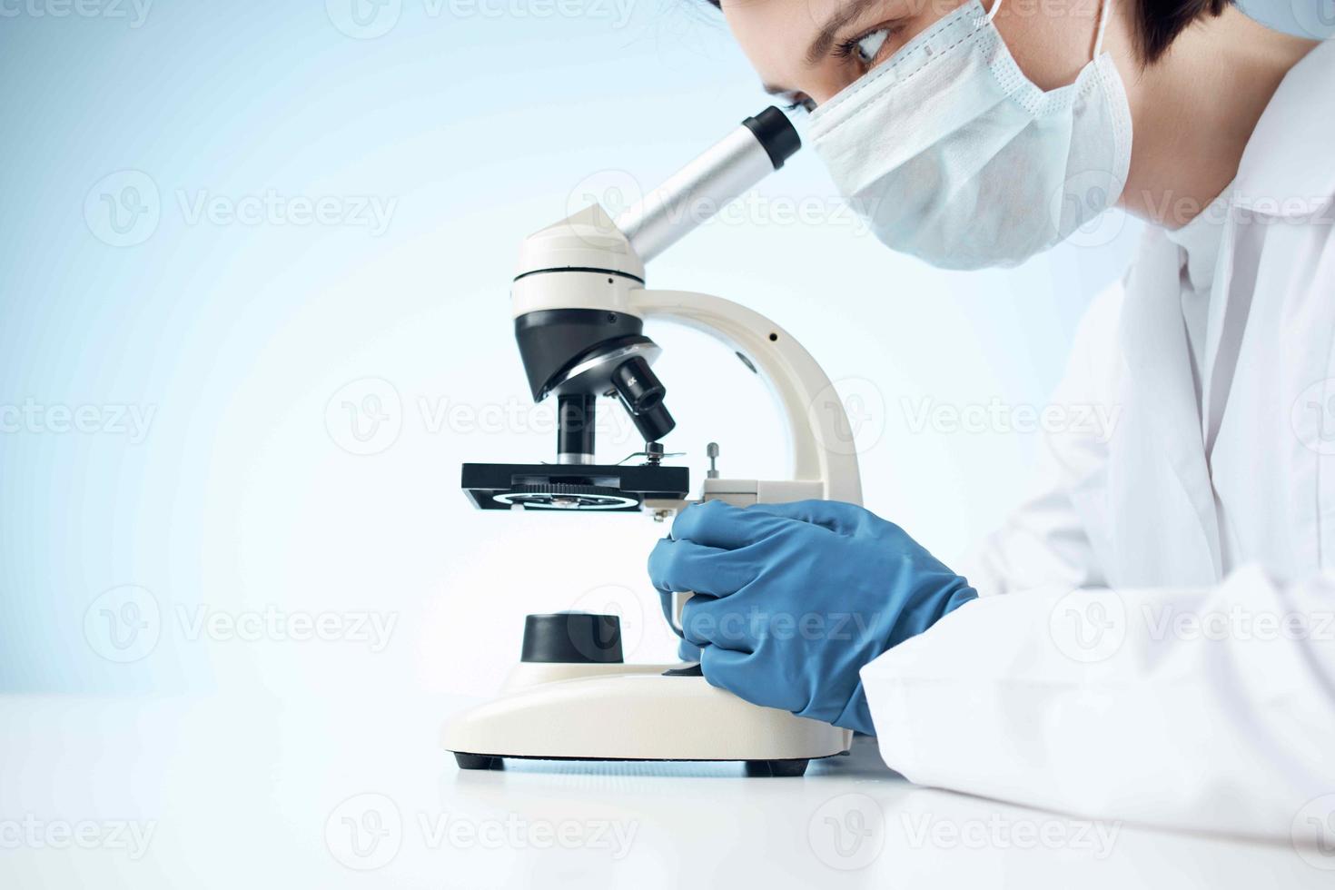 woman in laboratory looking through microscope close-up biotechnology science photo