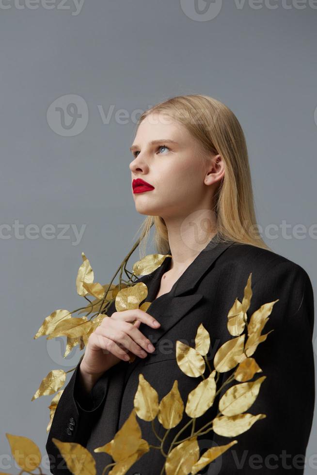 woman golden leaves black blazer red lips studio model unaltered photo