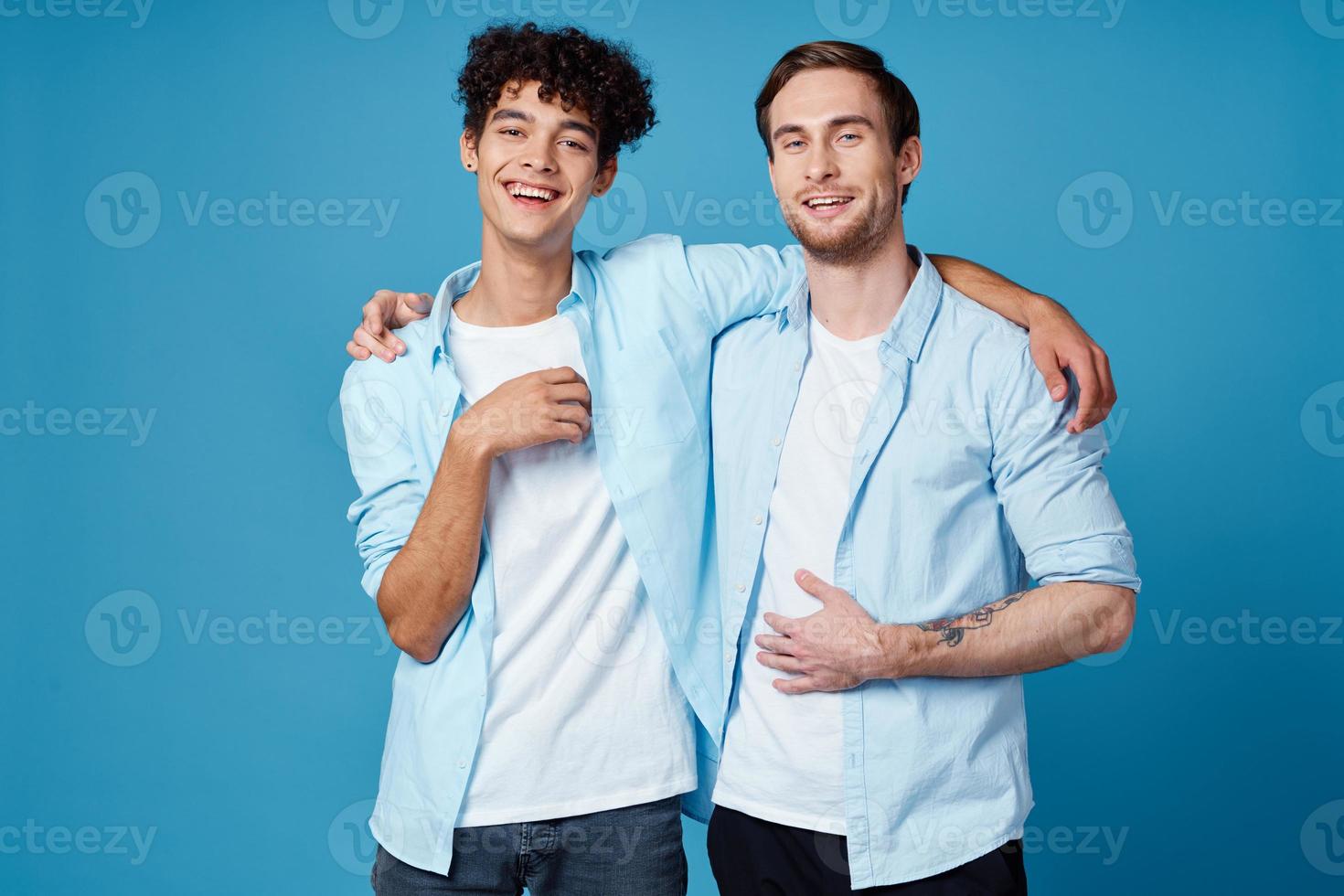 friends hugging on a blue background fun matching shirts white t-shirt pants photo