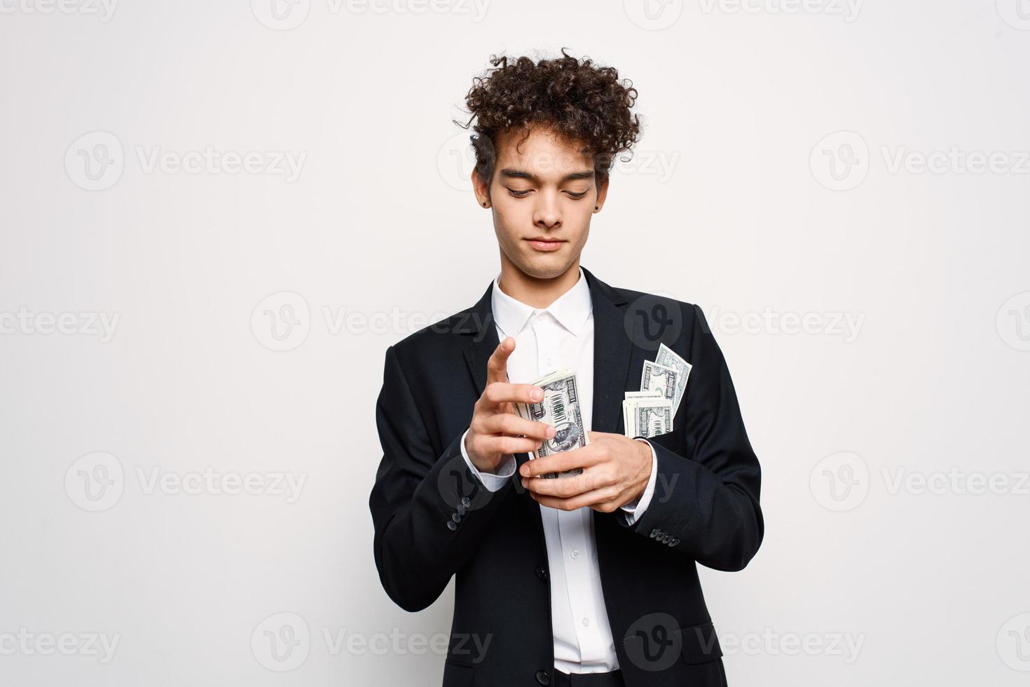 man in a suit a bundle of money in the hands of a businessman self-confidence photo
