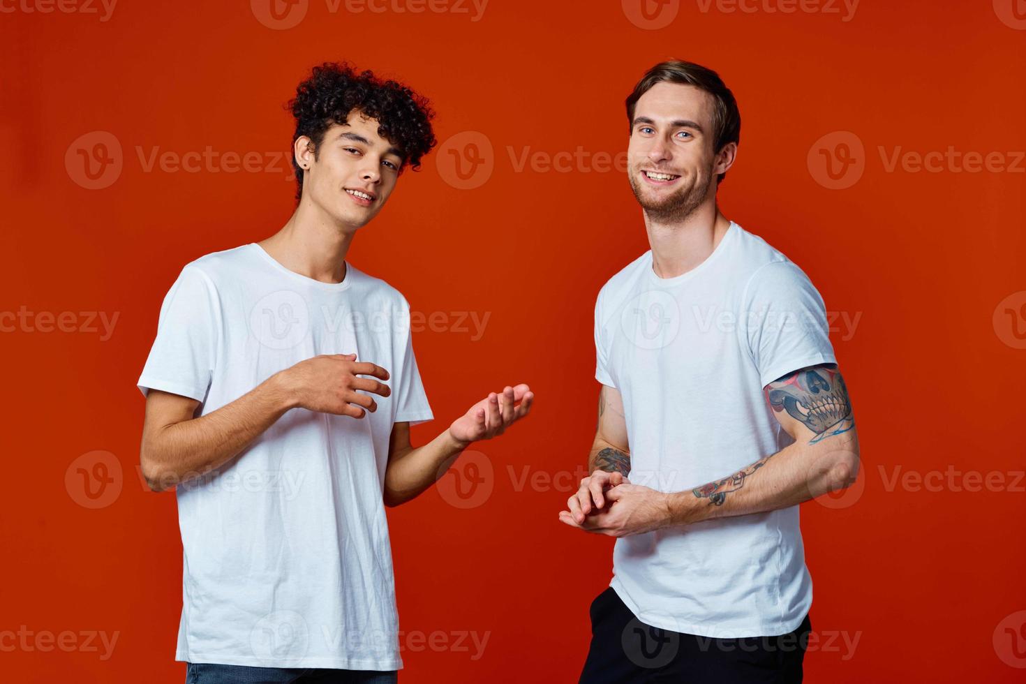 funny two friends in white t-shirts posing Studio photo