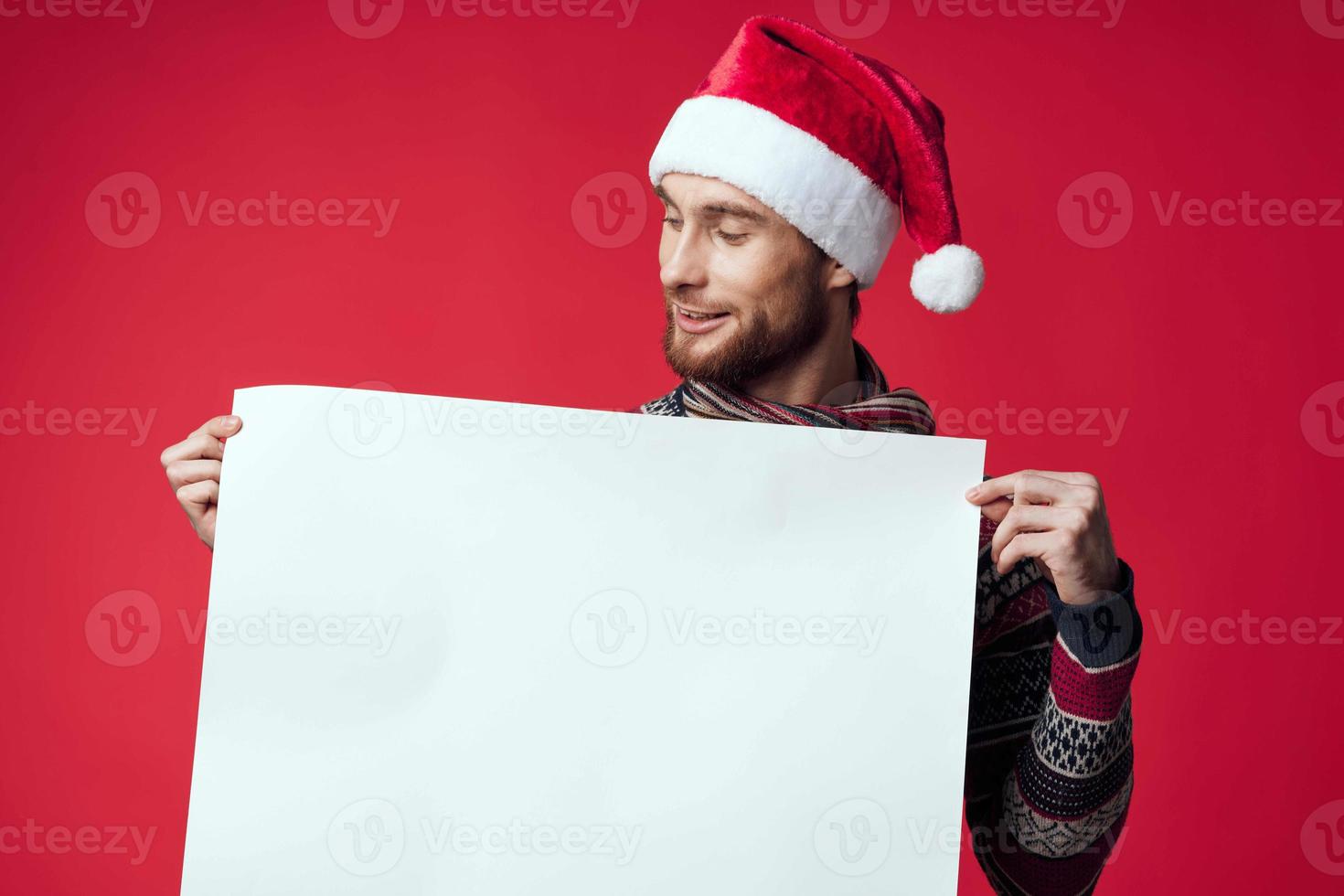 Cheerful man in New Year's clothes advertising copy space isolated background photo