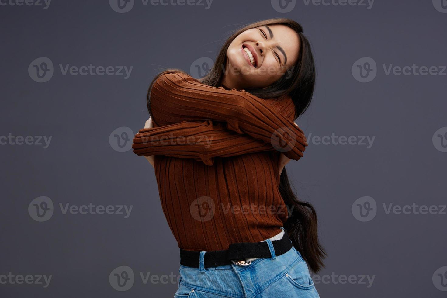 pretty woman fun brown sweater posing casual wear Gray background photo