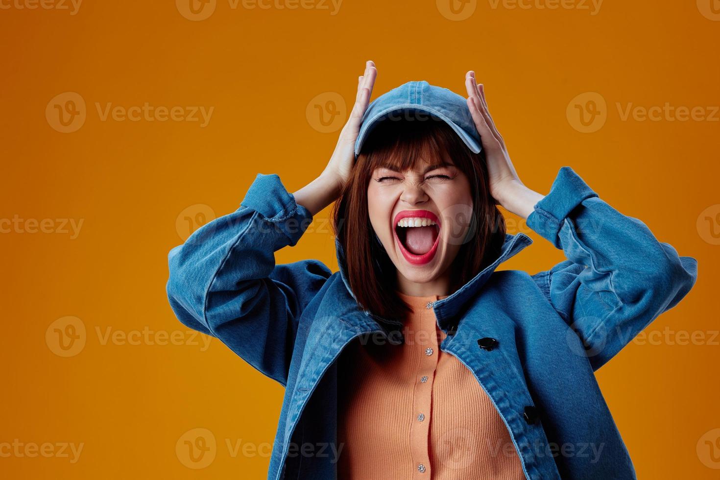 pretty woman in a cap and denim jacket posing studio model unaltered photo