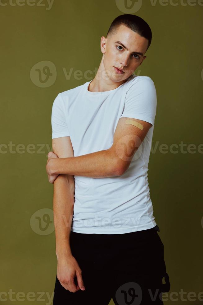 a man in a white t-shirt watch for a passport epidemic coronavirus studio photo