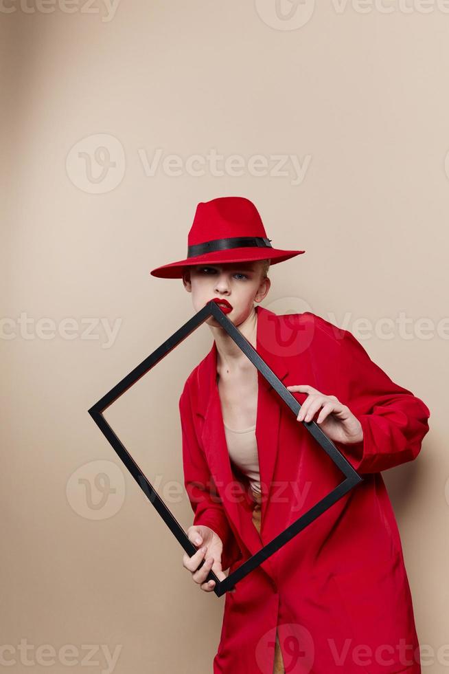glamorous woman frame in hand in red hat and jacket Lifestyle posing photo