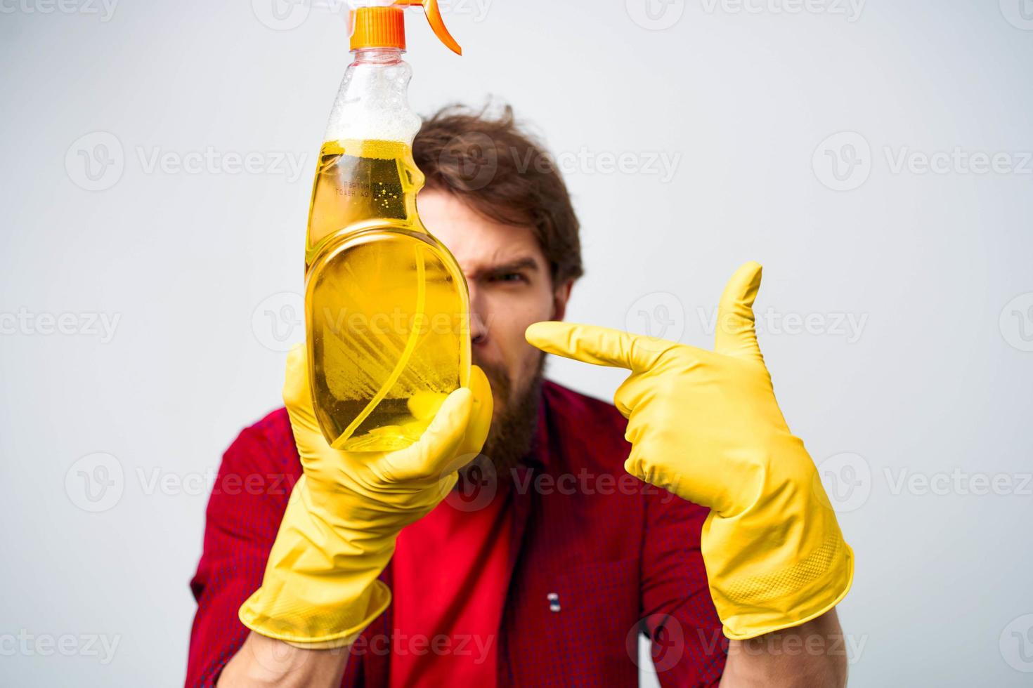 Man in yellow gloves detergent cleaning professional cropped view of housework lifestyle photo