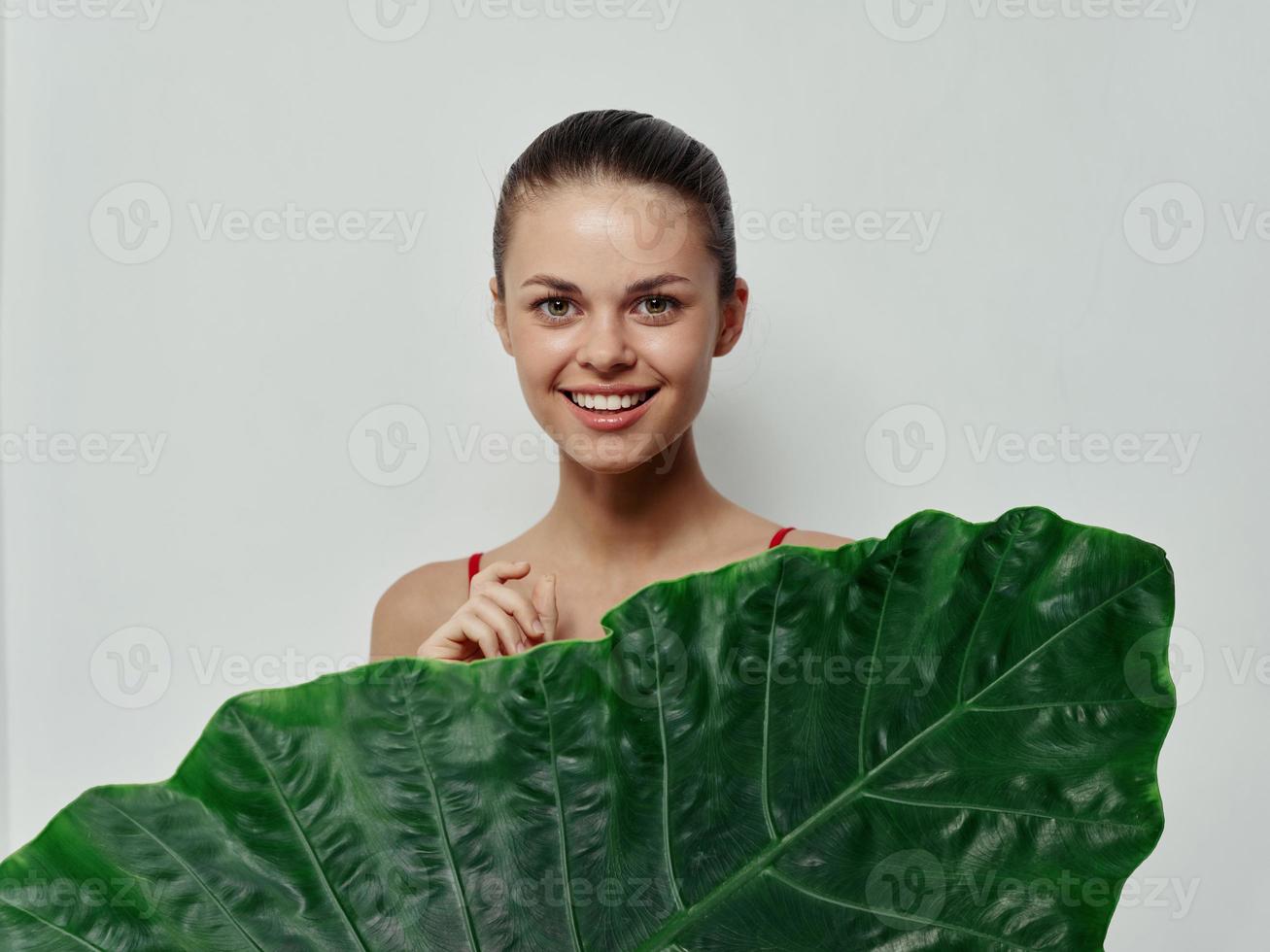 cheerful woman palm leaf Exotic bare shoulders studio photo