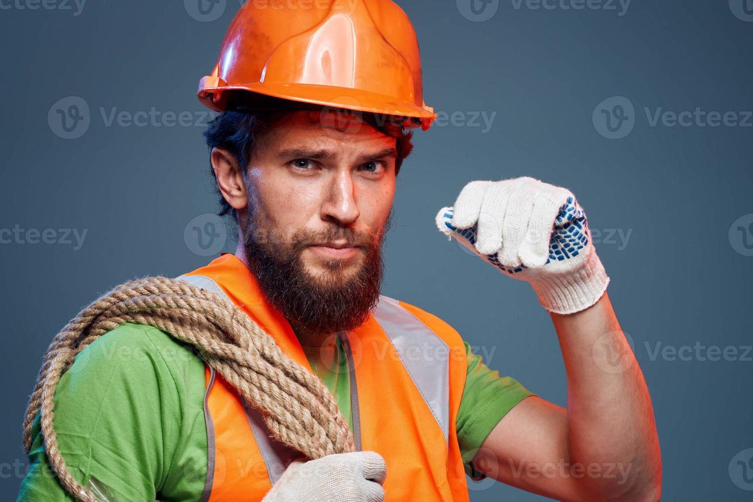 A working man in an orange paint rope in the hands of a construction professional photo