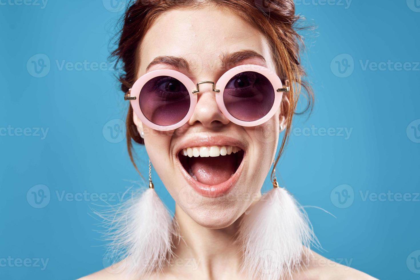 cheerful emotional woman wearing sunglasses fashion bright makeup decoration blue background photo