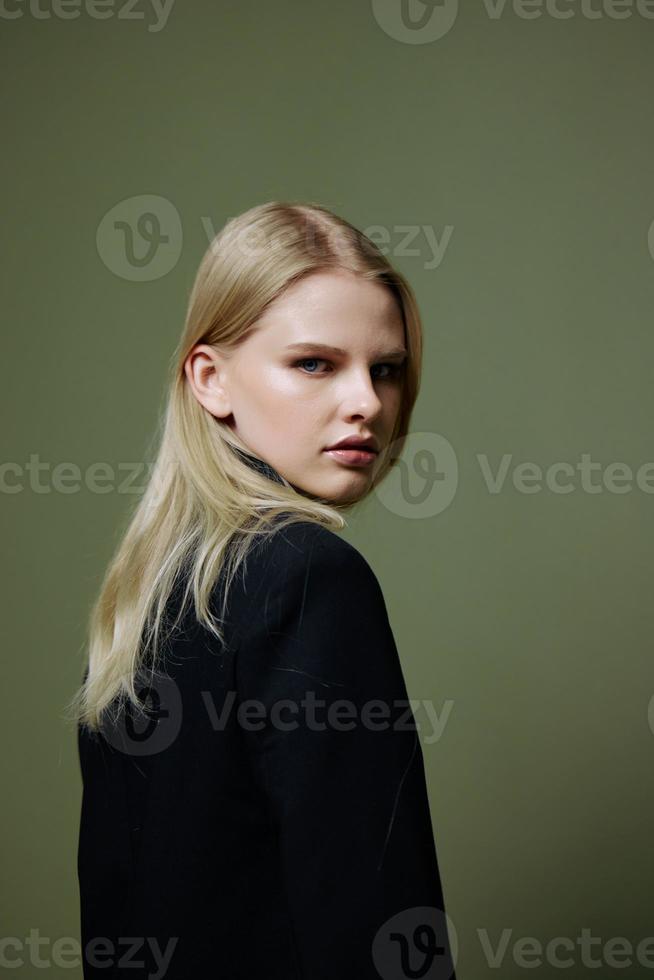 frio bandera para marcas un atractivo frio profesional modelo poses en un media vuelta y mira a el cámara en un verde aceituna antecedentes en el estudio foto