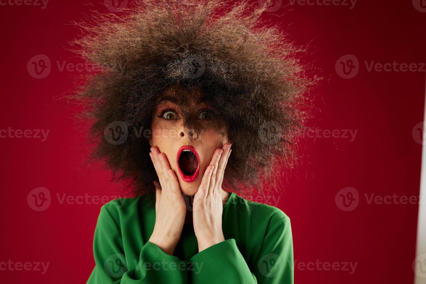 Beauty Fashion woman Afro hairstyle green dress emotions close-up red background unaltered photo