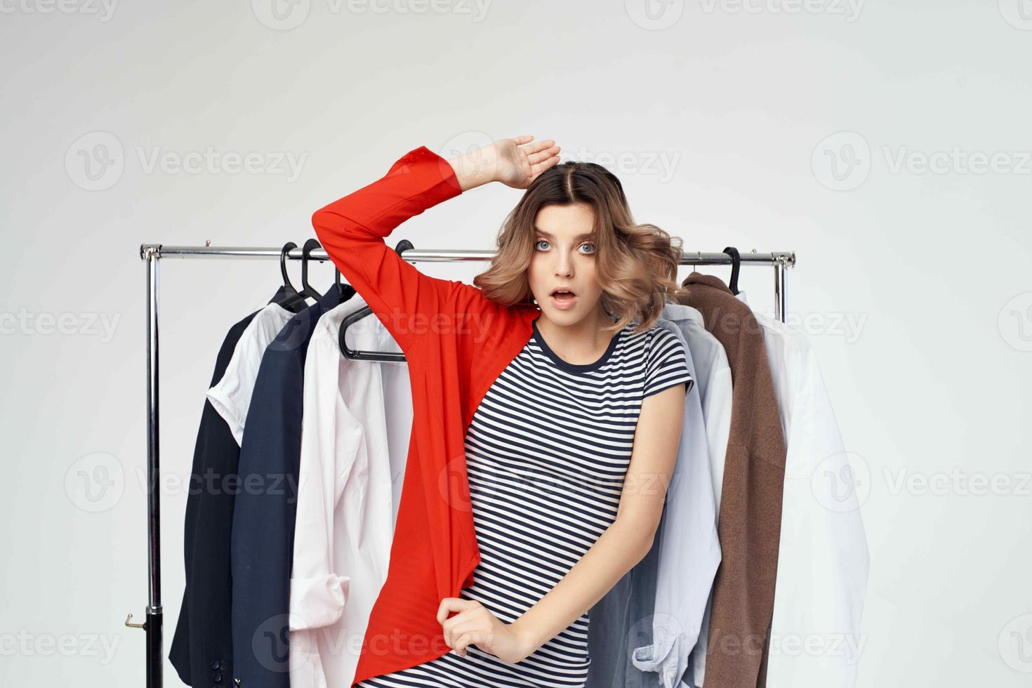 beautiful woman clothes hanger shopping light background photo