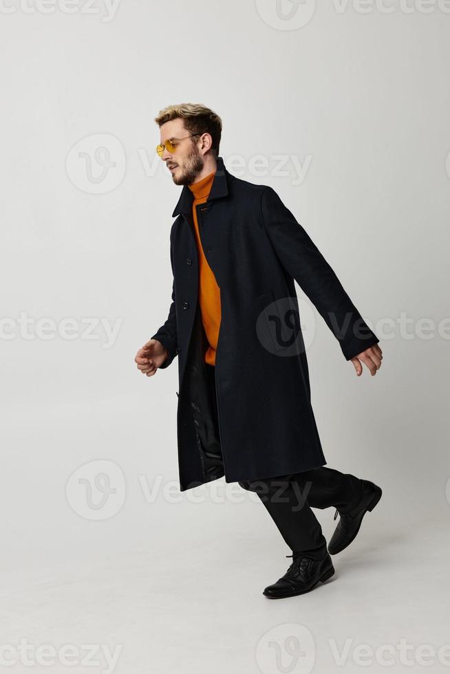 man in black coat yellow glasses fashion modern movement photo