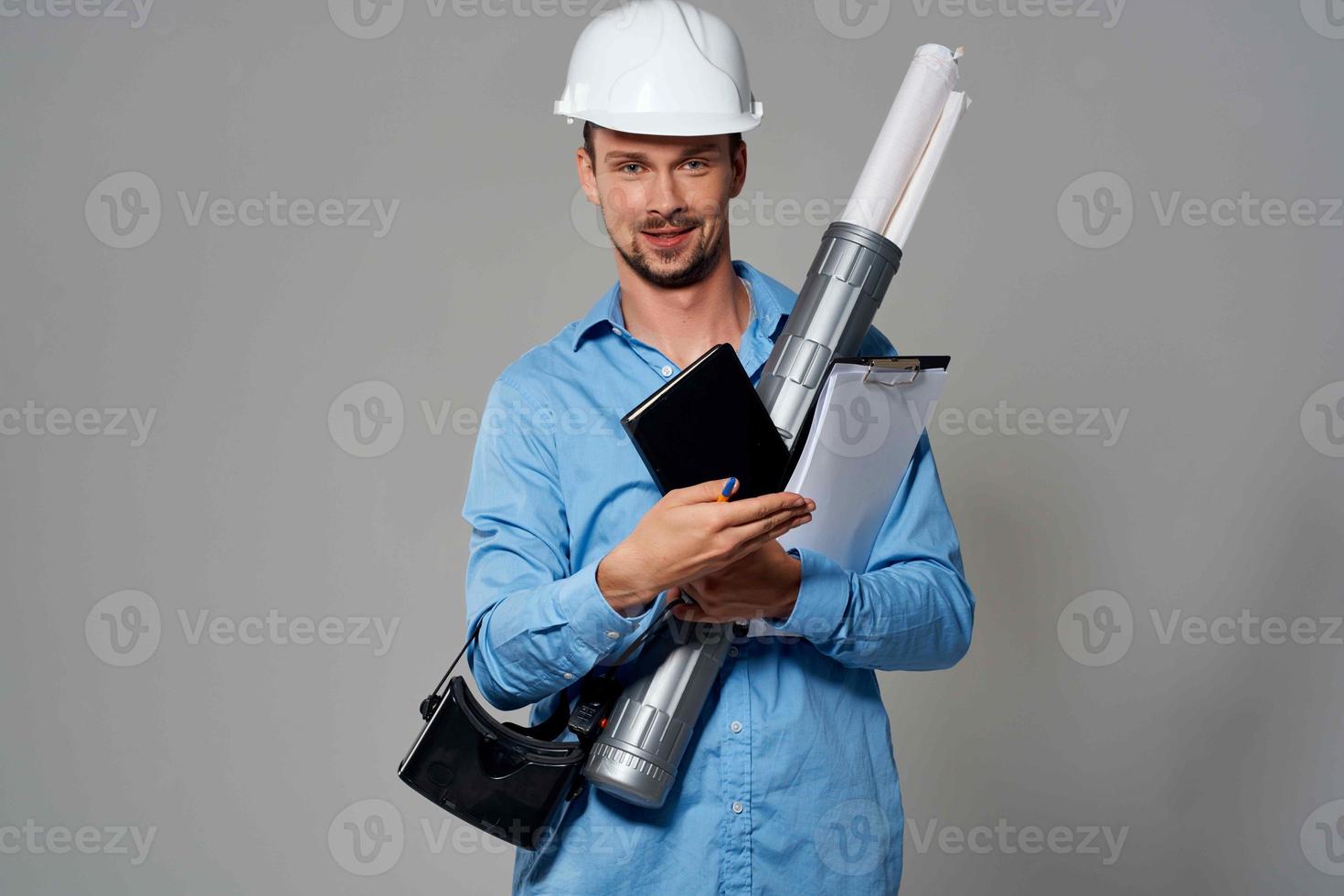Cheerful male engineer in white helmet construction blueprints work photo