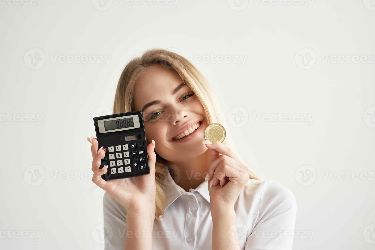 Businesswoman calculator in hand and bitcoin light background photo