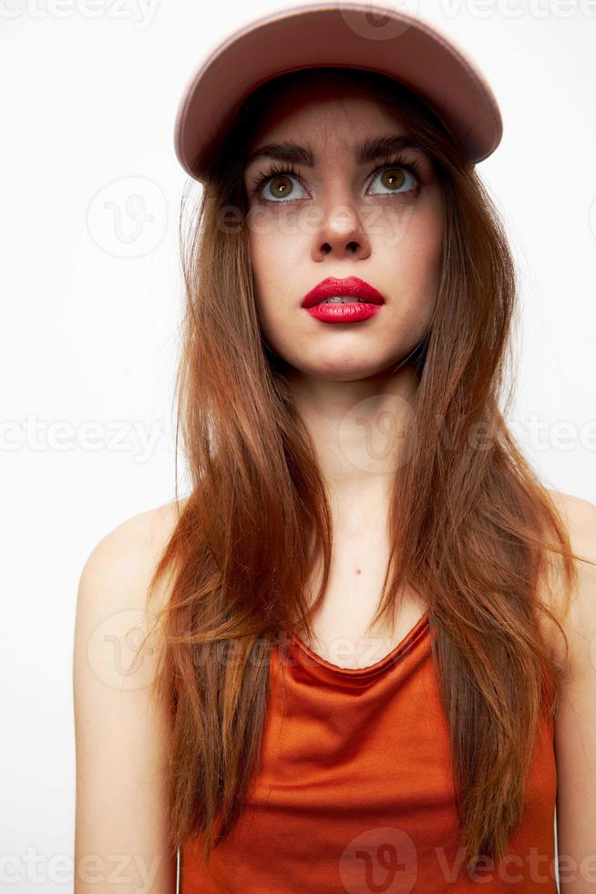 Woman with a cap Look up surprise of the model on her head red sundress photo