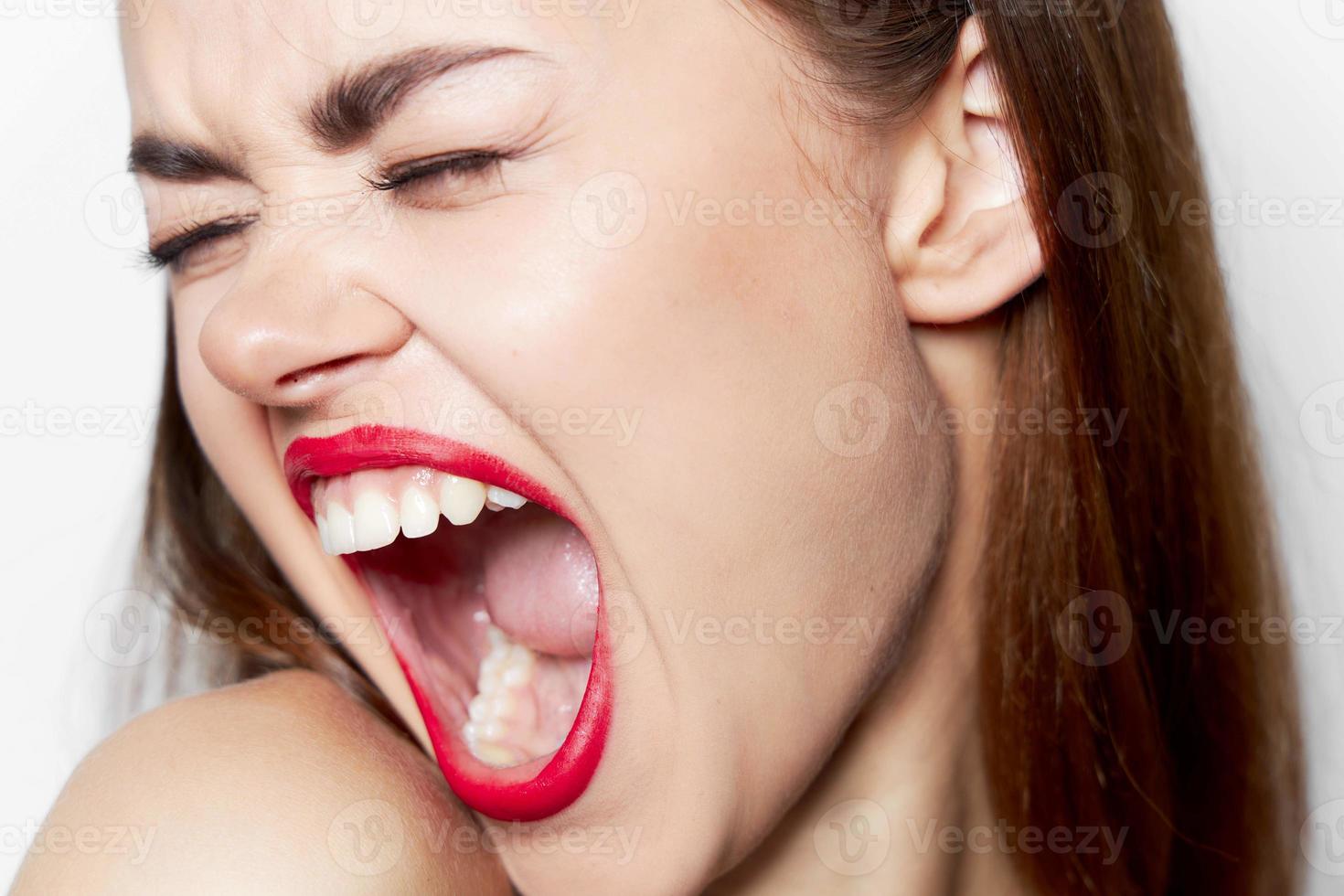 Close-up woman with wide open mouth and closed eyes photo