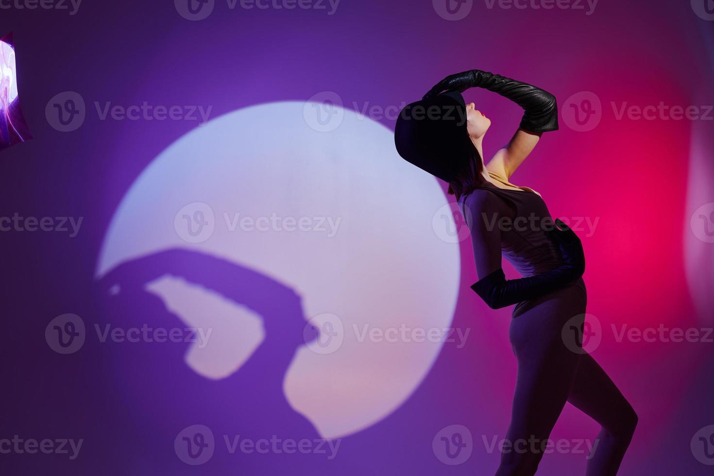 Beauty Fashion woman posing studio light neon purple background unaltered photo